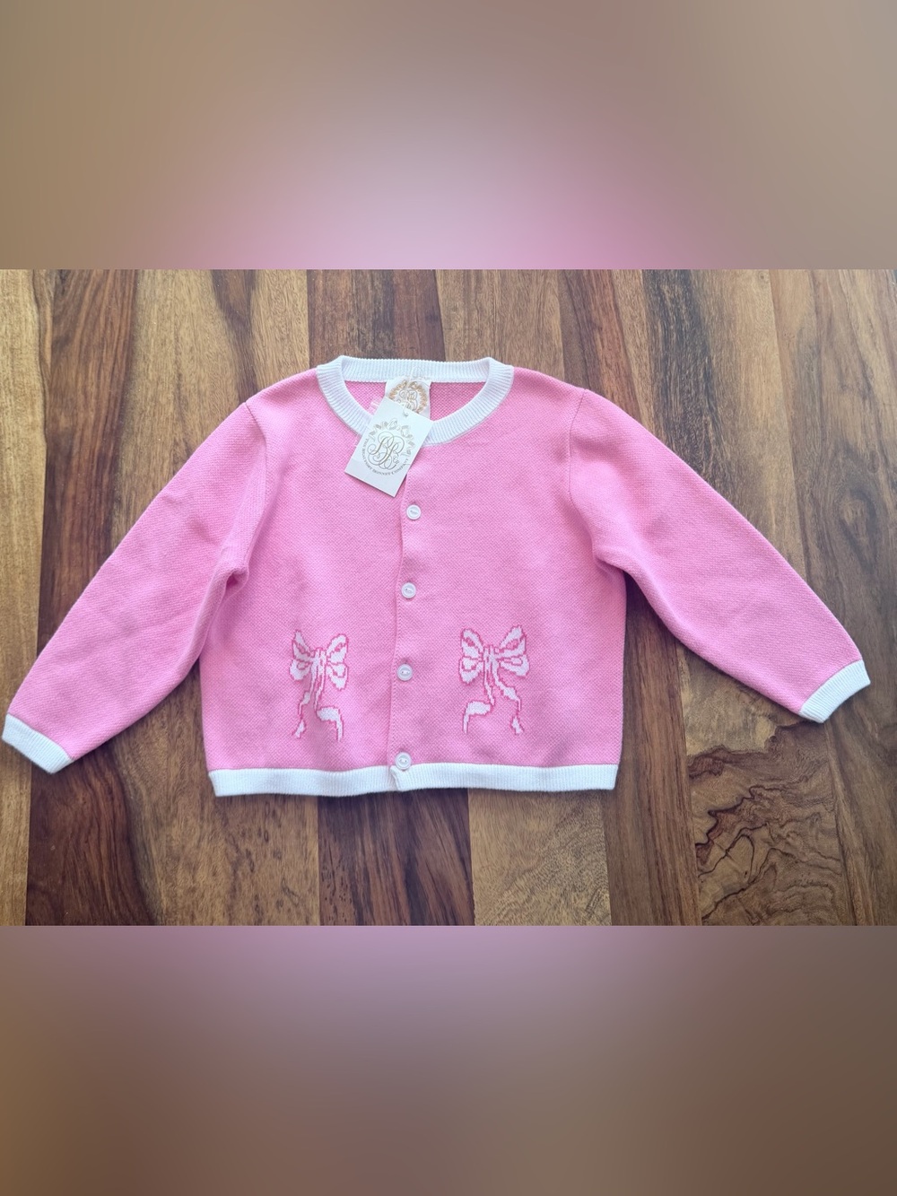 The Beaufort Bonnet Company Pink Knit Cardigan with White Trim and Bow Motifs